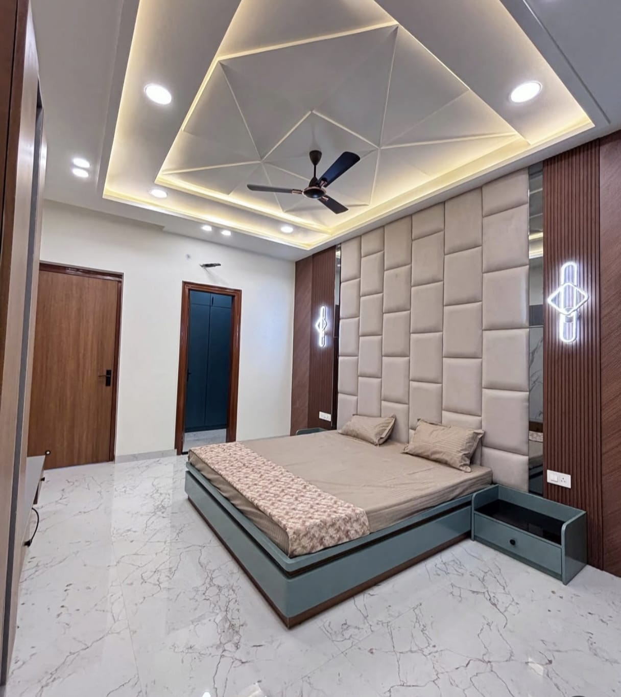 Master bedroom design with upholstered headboard and ambient cove lighting