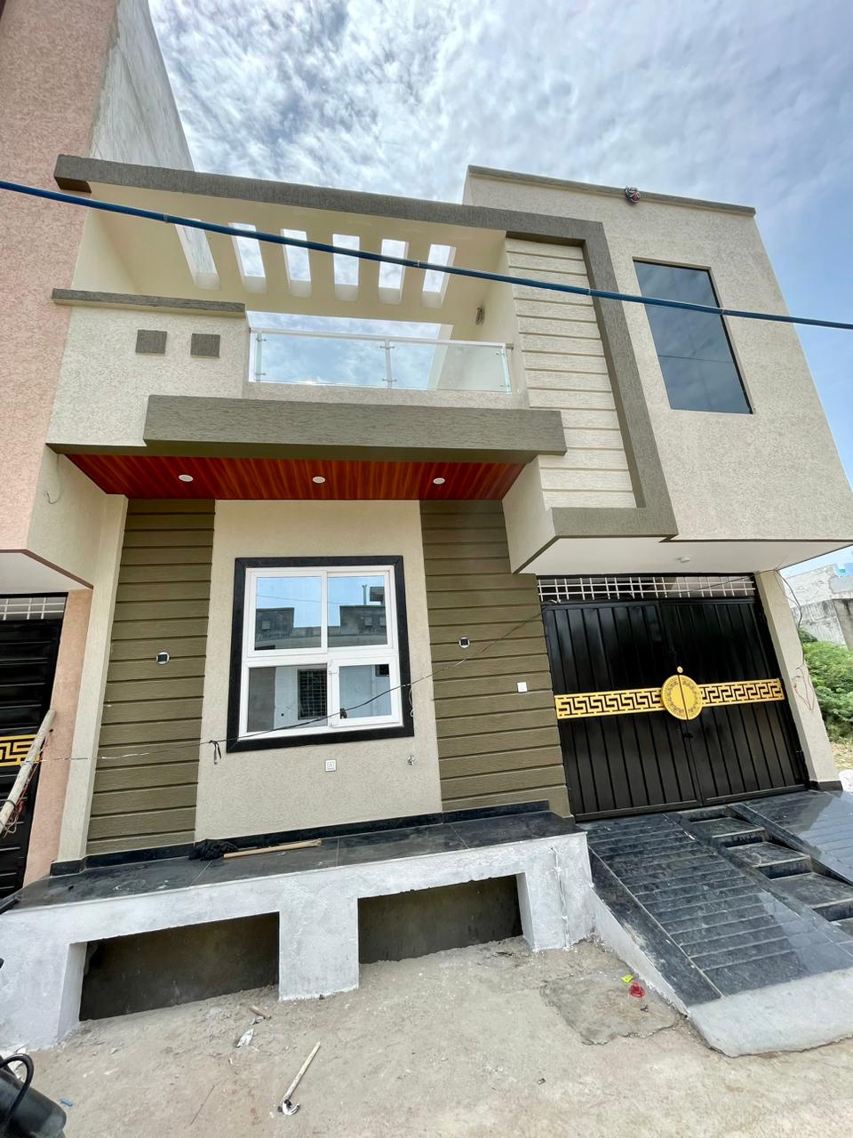 Contemporary 2-story villa elevation featuring olive horizontal groove plaster, open terrace pergola, and ornamental black gate